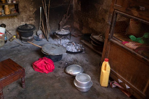 istock The kitchen inside a hut. African kitchen interior with hearth and stove. Interior of the modest vintage style poor kitchen, pots and utensils  lay on the ground. Hut kitchen in african village. 1366032301