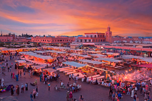Evening on Djemaa El Fna Square with Koutoubia Mosque, Marrakech, Morocco stock photo