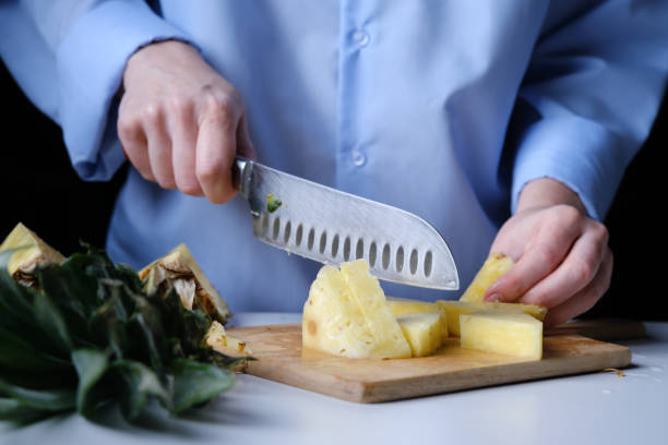 istock Person is cutting a pineapple 1366034771