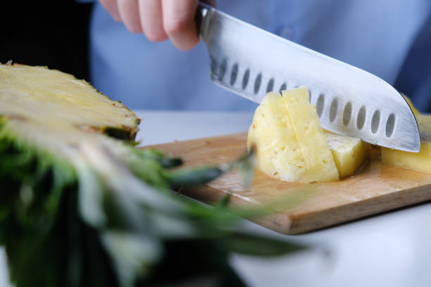istock Person is cutting a pineapple 1366034779
