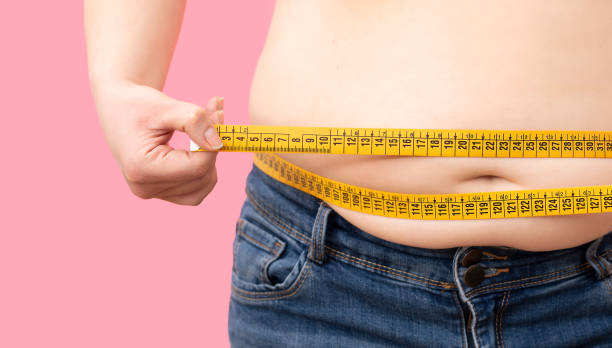 istock Mature Woman Measuring Midsection 1366038091