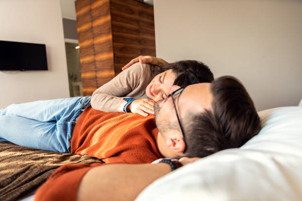 istock Couple resting together, lying on the bed. 1366042676