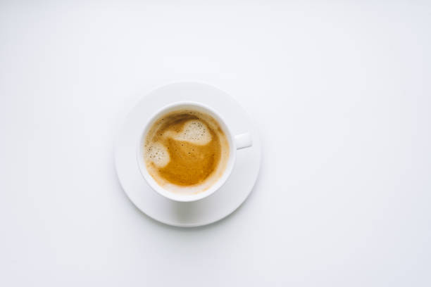 istock a white cup of coffee with a beautiful foam and a white saucer on a white background. isolate. copy space. High quality photo 1366046379