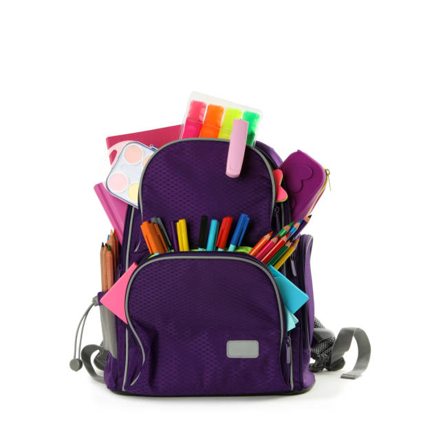 istock Purple backpack with different school stationery on white background 1366046386