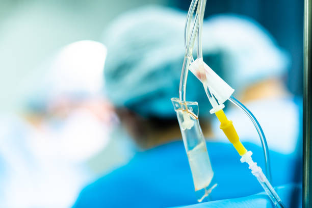 istock Transparent tubes of a medical dropper with saline on a blurred background. 1366046830