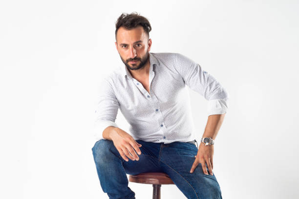 istock Handsome bearded man wearing shirt sitting against white background. 1366046919
