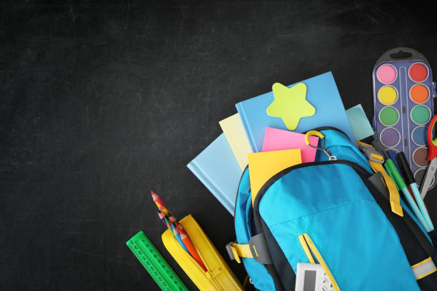 istock Blue backpack and different stationery on blackboard, flat lay with space for text. Back to school 1366047212