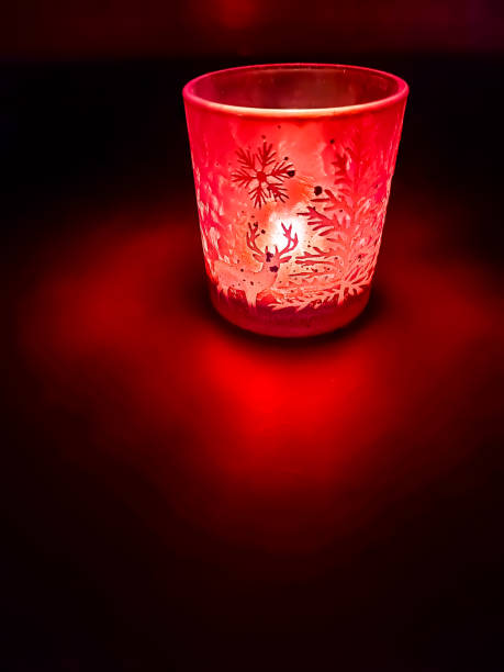 A captivating arrangement of glowing candles enclosed in a rustic metal lantern. The warm, flickering lights cast a romantic and cozy ambiance, perfect for intimate evenings or special occasions. The intricate metal framework adds a vintage touch to the atmospheric setup, ideal for Valentine's Day or any event celebrating warmth and love