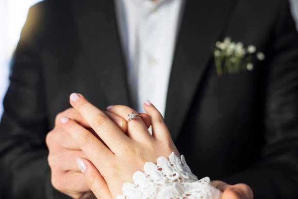 istock Couple wearing wedding ring at wedding day of them. 1366049345