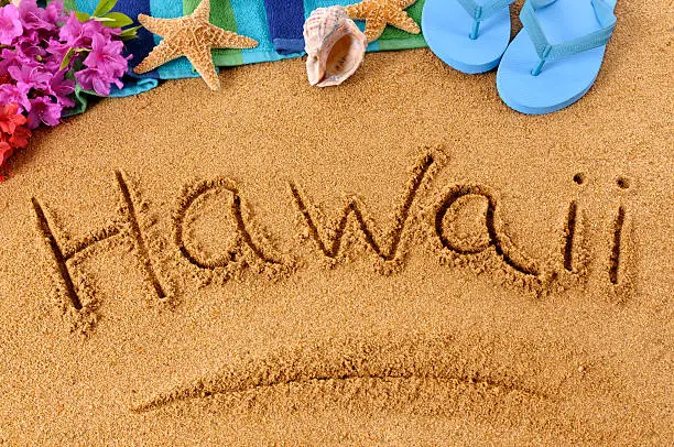 The word Hawaii written on a sandy beach, with flowers, beach towel, starfish and flip flops (studio shot - warm color and directional light are intentional).  To see my complete collection of beach scenes please  CLICK HERE.   Alternative file shown below: