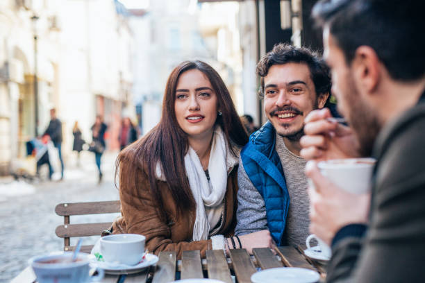 istock Friends talking and laughing in a cafe 1366052135