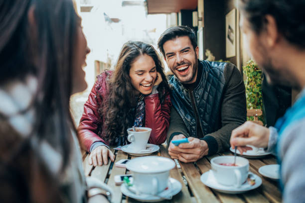 istock Friends talking and laughing in a cafe 1366052136
