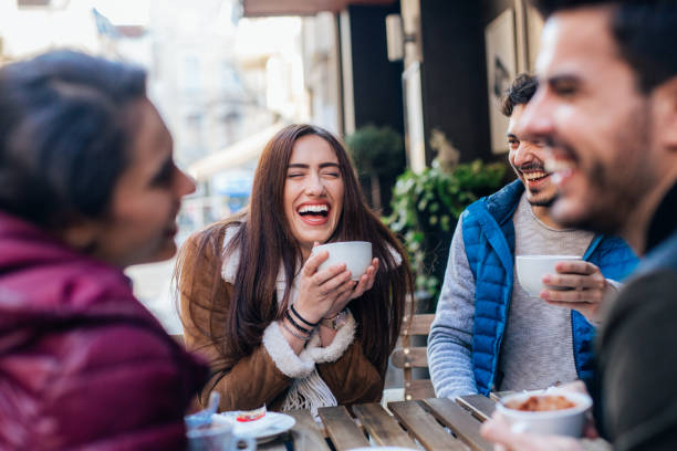 istock Friends talking and laughing in a cafe 1366052139