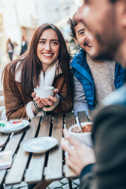 istock Friends talking and laughing in a cafe 1366052141