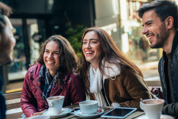 istock Friends talking and laughing in a cafe 1366052146
