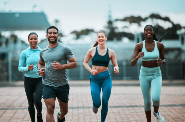 Shot of a group of friends hanging out before working out together My squad and i tear up the road running stock pictures, royalty-free photos & images