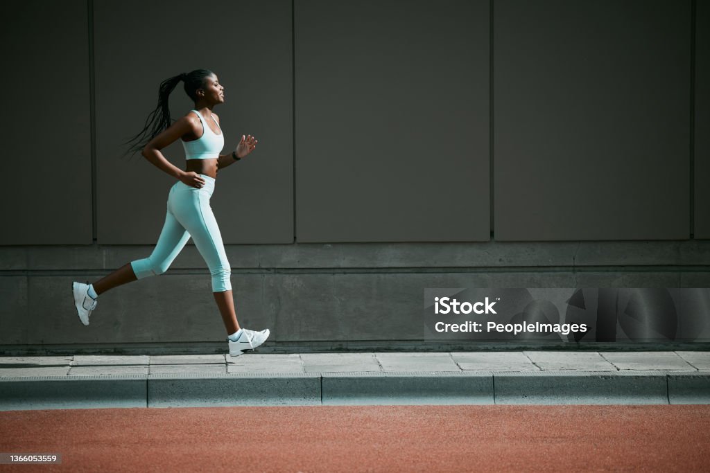 Shot of a young woman running outside I feel the dopamine surging Running Stock Photo