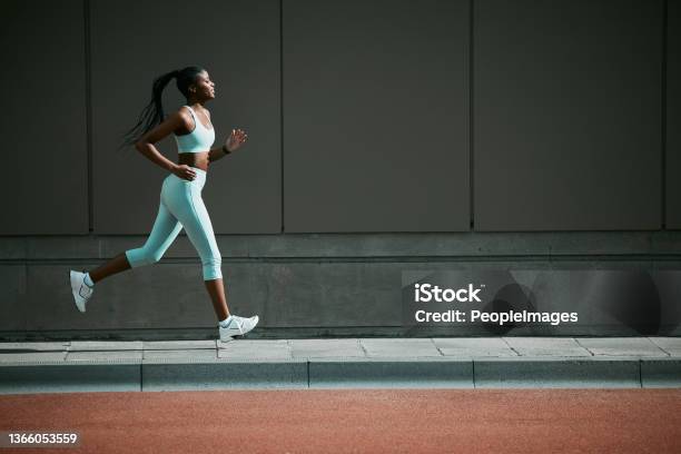 Shot Of A Young Woman Running Outside Stock Photo - Download Image Now - Running, Women, One Woman Only