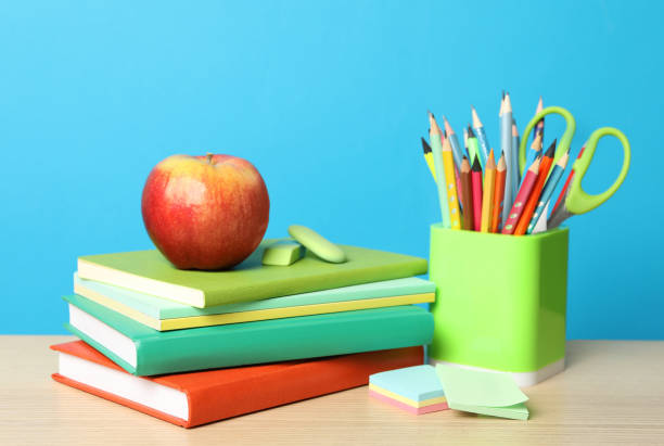 istock Composition with different school stationery on wooden table against light blue background. Back to school 1366053952