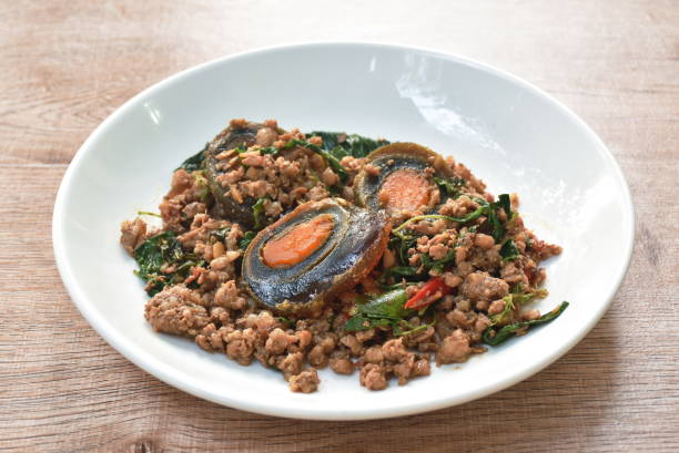 istock slice boiled black preserved egg dressing spicy fried chop pork and basil leaf 1366054148