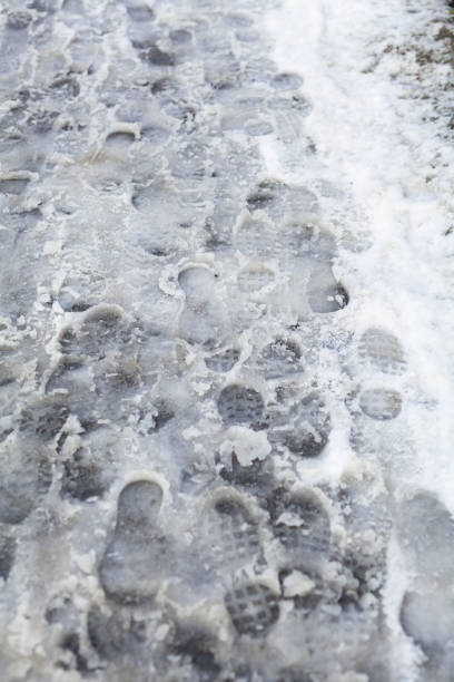 istock slippery sidewalk in winter covered with slush full of footprints 1366055325