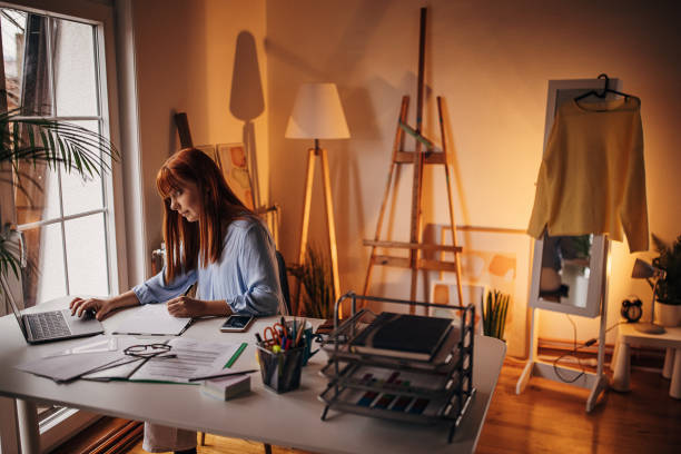 istock Redhead woman working in home office 1366056245