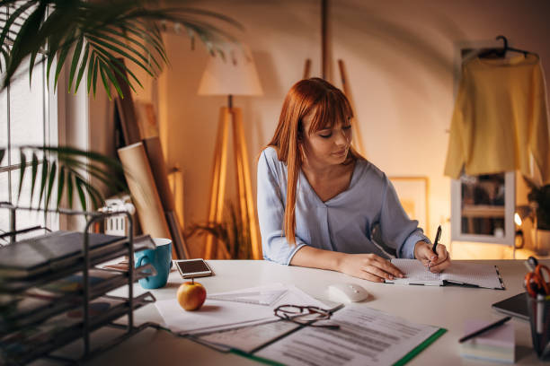 istock Redhead woman in home office 1366056311