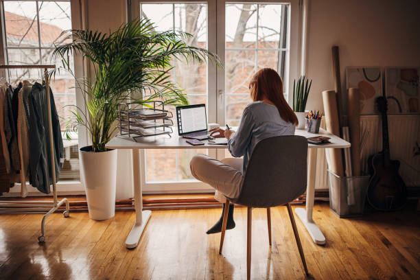 istock Redhead woman working from home 1366056517