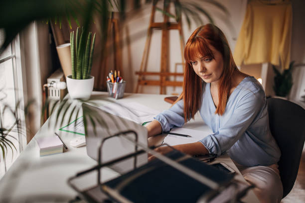 istock Redhead woman in home office 1366056619