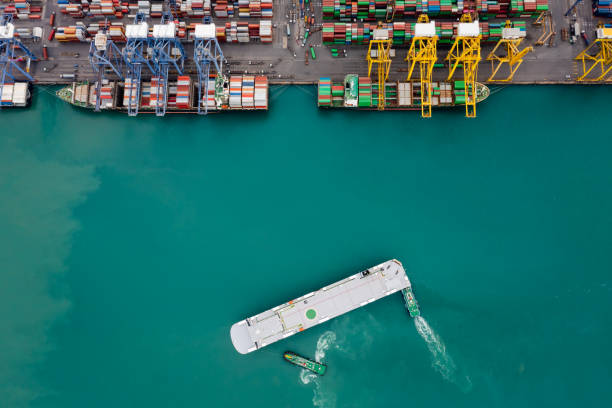 istock Aerial top view tugboat dragging Large RoRo (Roll on/off) into Commercial dock import and export international on the green sea 1366057891