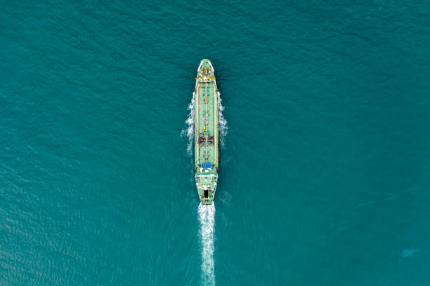 aerial top view oil ship tanker full speed with beautiful wave and splash water in line of transportation from refinery on the sea. - oil storage tank storage compartment fuel and power generation imagens e fotografias de stock