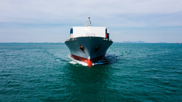istock container ship full speed on the green sea business services Transportation import and export international annd Worldwide and cloud sky background 1366058071
