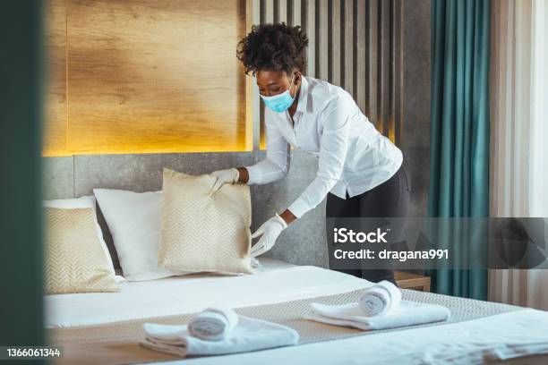 Housekeeper Or Maid Cleaning Hotel Room Stock Photo - Download Image Now - Sheet - Bedding, Black People, Housekeeping Staff