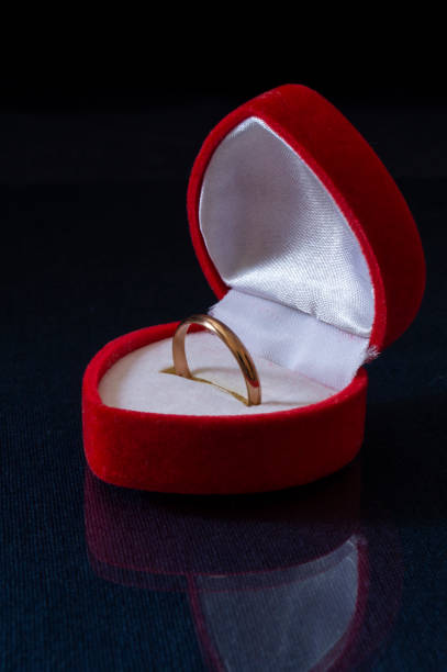 istock A gold ring in a red box on the table. 1366065119