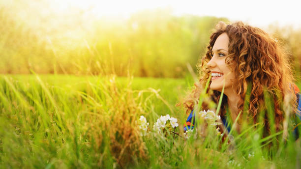 Pretty smiling girl relaxing outdoor stock photo