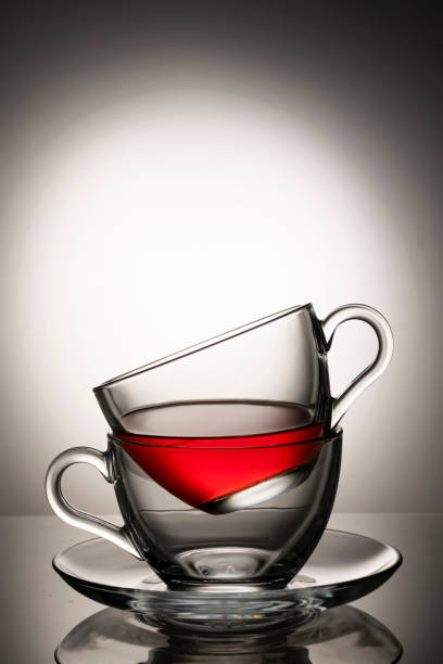 istock Two cups of tea against monochrome background 1366066917
