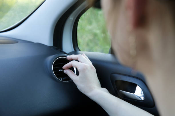 istock Hand ajusting the air conditioner in the car 1366067199