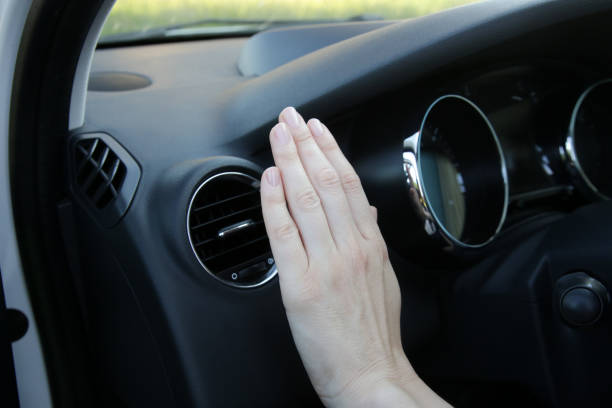 istock Hand checking the air conditioner in the car 1366067649