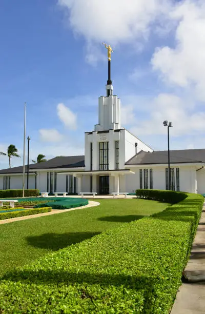 Tongatapu island, Tonga: Mormon temple - Church of Jesus Christ of Latter-day Saints - Tonga is the number one country in the world for Mormonism, on a per capita basis (over 60%) - Nuku'alofa's main temple, located near Matangiake on Loto Road - Nuku'alofa Tonga Temple / Liahona (formerly the Tongan Temple), built with a modern single-spire design with the angel Moroni - architect Emil B. Fetzer, LDS church.