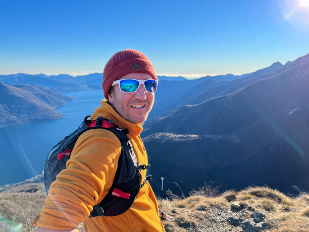 istock Male trail runner pauses at mountain top 1366068842