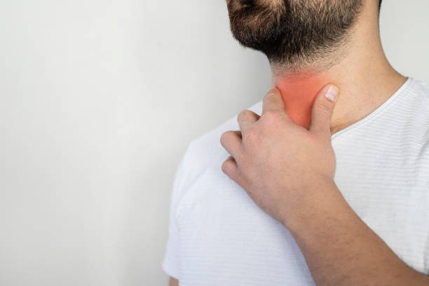istock Sore throat. Men touching the neck 1366071736