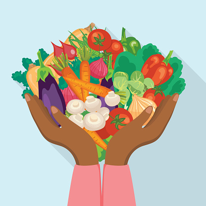 A pair of hands holding a mix of fresh vegetables on a flat color background.