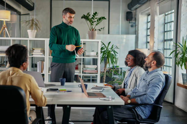 istock Male coach presenting business plan, strategy or new project on meeting 1366073727