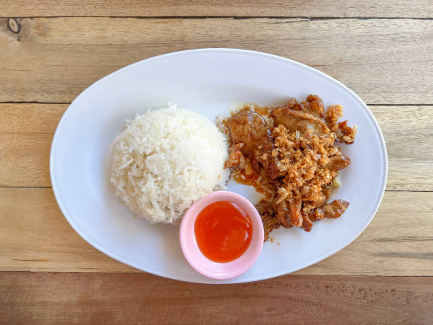 istock Fried garlic pork with Rice on white plate 1366074260