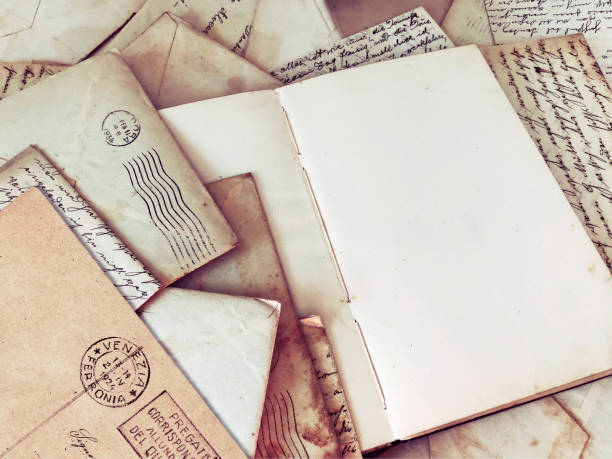 istock Vintage open blank journal among old mail and and written papers 1366074352