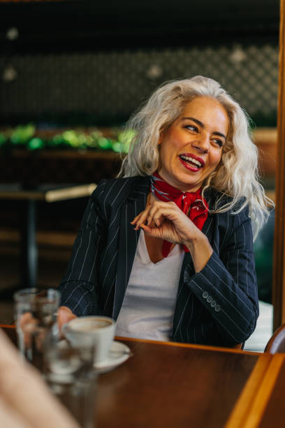 istock Smiling middle age woman at cafe 1366074449