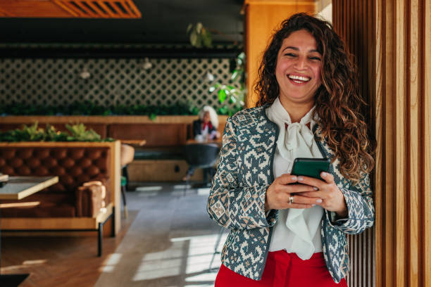 istock Young woman using cellphone indoors 1366074489