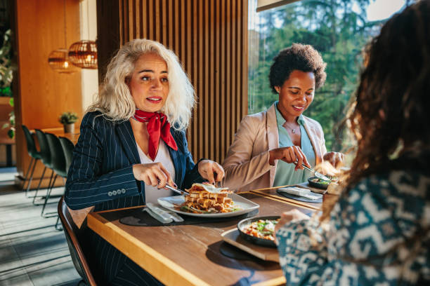 istock Women having food at restaurant table 1366074515