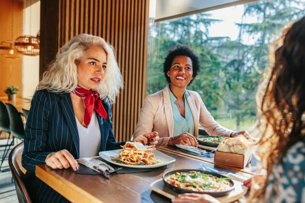 istock Women having food at restaurant table 1366074823