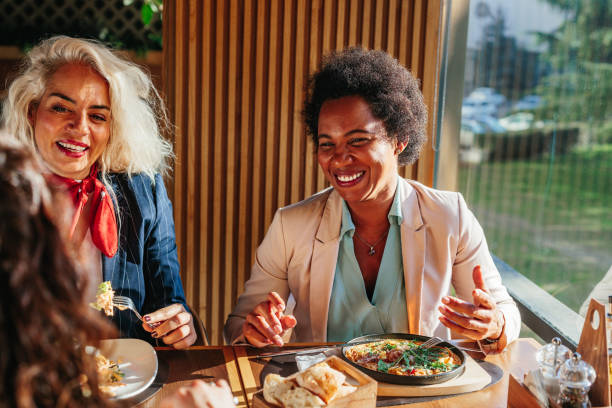Female friends having a great time in restaurant stock photo